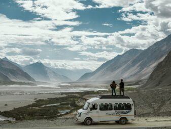 two person on top of white van