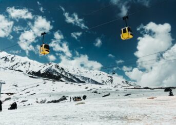 a ski lift going up a snowy mountain