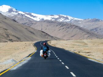 man riding motorcycle on road during daytime