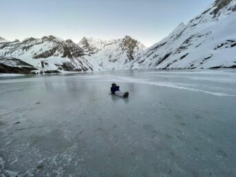 man laying on the frozen lake